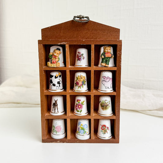 Ceramic Thimbles in Wooden Shelf